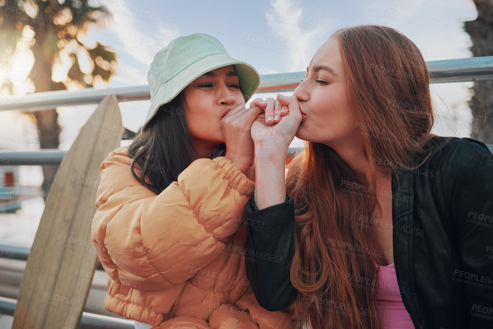 Buy stock photo Playful, kiss and friends with a hand promise, support and secret in the city of California. Happy, together and women with affection, outdoor conversation and playing with happiness as besties