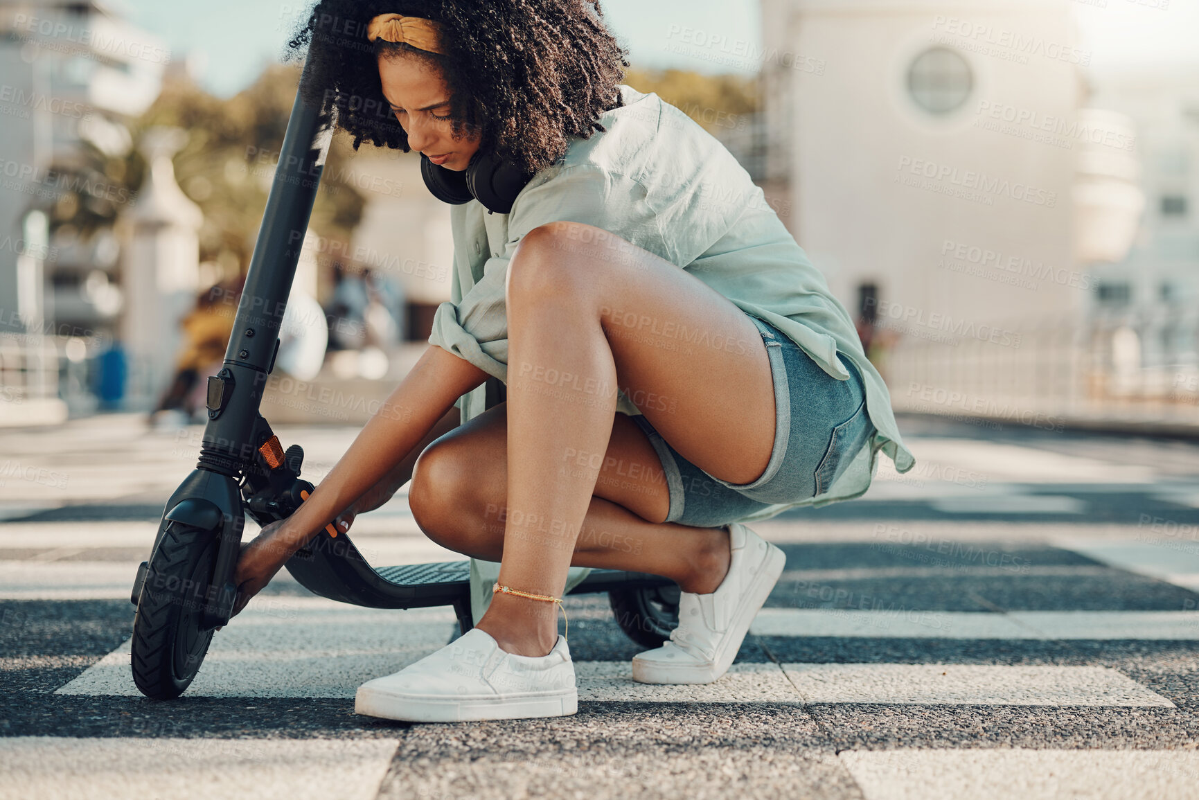Buy stock photo Black woman, scooter and eco friendly travel in city, adventure and fixing the wheel of ebike outdoor. Sustainable transportation, freedom with carbon footprint and transport in urban street in Miami