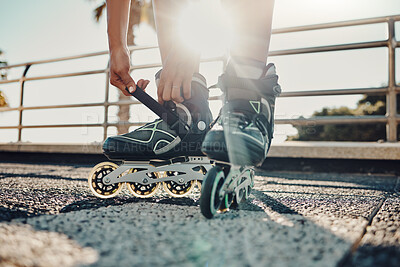 Buy stock photo Fitness, hands and tie roller skates in city to start workout, health and wellness exercise. Sports practice, training and black woman skater tying shoes in street to get ready for skating outdoors.