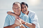 Senior couple, portrait and hug at beach for laughing, love and relax on summer holiday, vacation or date. Happy retirement, man and woman embrace at sea for happiness, support and smile in sunshine