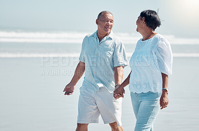 Buy stock photo Retirement, love and walking on the beach with a senior couple outdoor together on the sand by the ocean. Nature, walk or holding hands with a mature man and woman outside with the sea or water