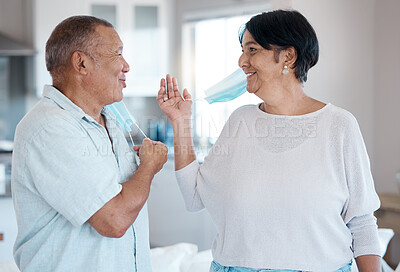 Buy stock photo Covid, remove home mask and senior couple together talking with a smile in a kitchen. Happy man, mature and marriage of a grandparents in house laughing with happiness after end of virus quarantine 