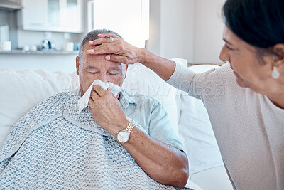 Buy stock photo Covid, tissue and healthcare with a man sick at home with his wife taking care of him in the living room. Medical, blowing nose and fever with a senior woman looking after her husband in a house