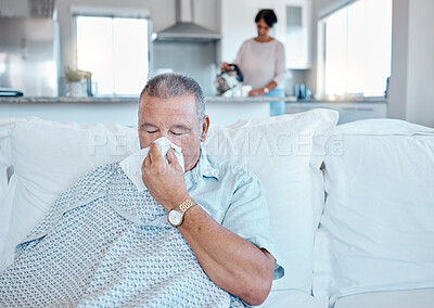 Buy stock photo Allergies, sick and senior man on sofa cleaning his nose for retirement, pension or elderly healthcare home. Virus, bacteria or allergy of old person on couch in house and woman in kitchen for help