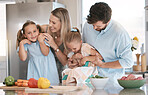 Portrait, playful and family cooking food, bonding and children helping in the kitchen for lunch. Happy, laughing and parents playing with girl kids while preparing dinner together for quality time