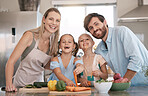 Portrait of mom, dad and children cooking in kitchen with vegetables for lunch, food or meal prep together. Family, smile and parents with girls learning, teaching and helping for child development