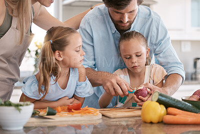 Buy stock photo Cooking, kitchen and parents with children with vegetables for healthy lunch, food nutrition or meal prep together. Family, chef skills and dad with girls learning, teaching and help cut ingredients