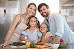 Kitchen, cooking and portrait of parents and children with vegetables for healthy diet, food or meal prep together. Family, smile and mom, dad and girls learning, teaching and helping cut ingredients