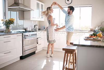 Buy stock photo Couple, bonding or dancing in kitchen, house or family home in support, love or trust in fun activity, energy freedom or celebration. Smile, happy or dancer man and woman in romance marriage ballroom