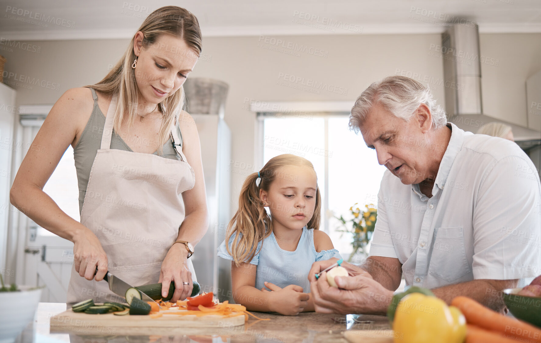 Buy stock photo Family home, cooking a vegetables with a child helping mother and grandfather in the kitchen. Woman, man and girl kid learning to make lunch or dinner with love, care and bonding over food together