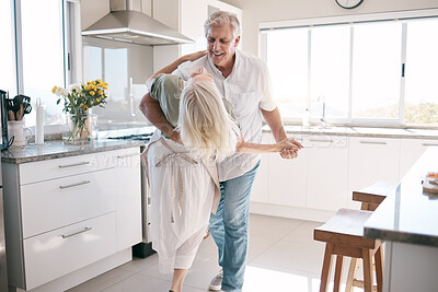 Buy stock photo Senior couple dancing, kitchen and happiness with love, care and support in morning at house. Elderly man, old woman and dance together with smile, hands and support in retirement in home with trust