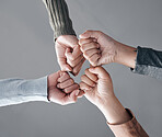 People, hands and fist bump in trust for unity, collaboration or team agreement in solidarity. Hand of support group bumping fists in teamwork, partnership or coordination for community achievement