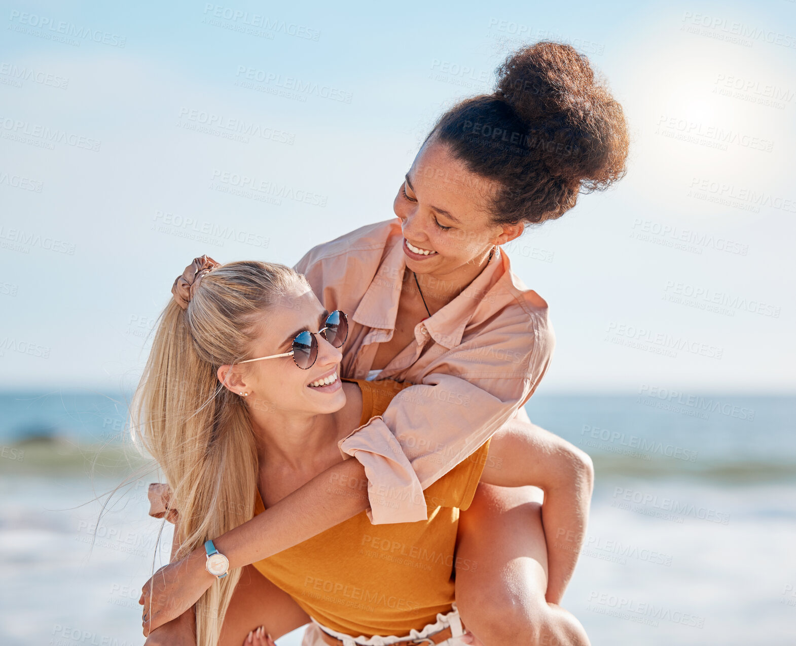 Buy stock photo Piggyback, beach and happy couple of friends with lgbtq, lesbian or love freedom on summer vacation. Blue sky, ocean and diversity women on date, fun support and valentines holiday with hug by sea