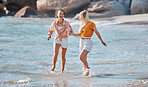 Couple holding hands on beach, lesbian and happy in ocean, gay women outdoor with adventure and freedom to love. Interracial, laughter and holiday in Australia, lgbtq with travel and running in water