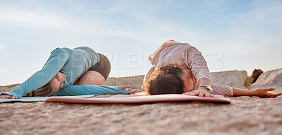 Buy stock photo Yoga, women or stretching on beach mat in workout, training or bonding exercise twist for back pain. Child pose, relax or yogi friends in nature pilates or fitness flexibility for healthcare wellness