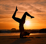 Yoga, silhouette or handstand on sunset beach, ocean or sea in evening workout or relax exercise training. Yogi, woman or sand balance pose at sunrise for healthcare wellness fitness or strong body