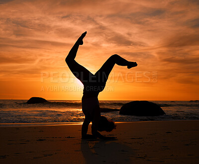 Buy stock photo Yoga, silhouette or handstand pose on sunset beach, ocean or sea in evening workout or relax exercise training. Yogi, woman or sand balance at sunrise for healthcare wellness fitness or strong body