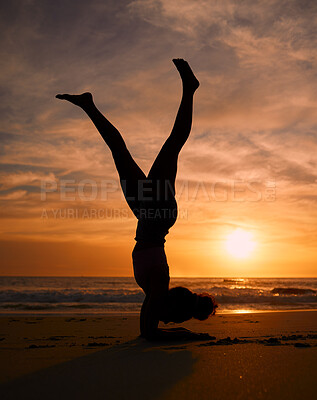 Buy stock photo Yoga woman, silhouette or handstand on sunset beach, ocean or sea in workout or relax exercise training. Yogi, pilates or sand balance pose at sunrise for healthcare wellness fitness or strong body