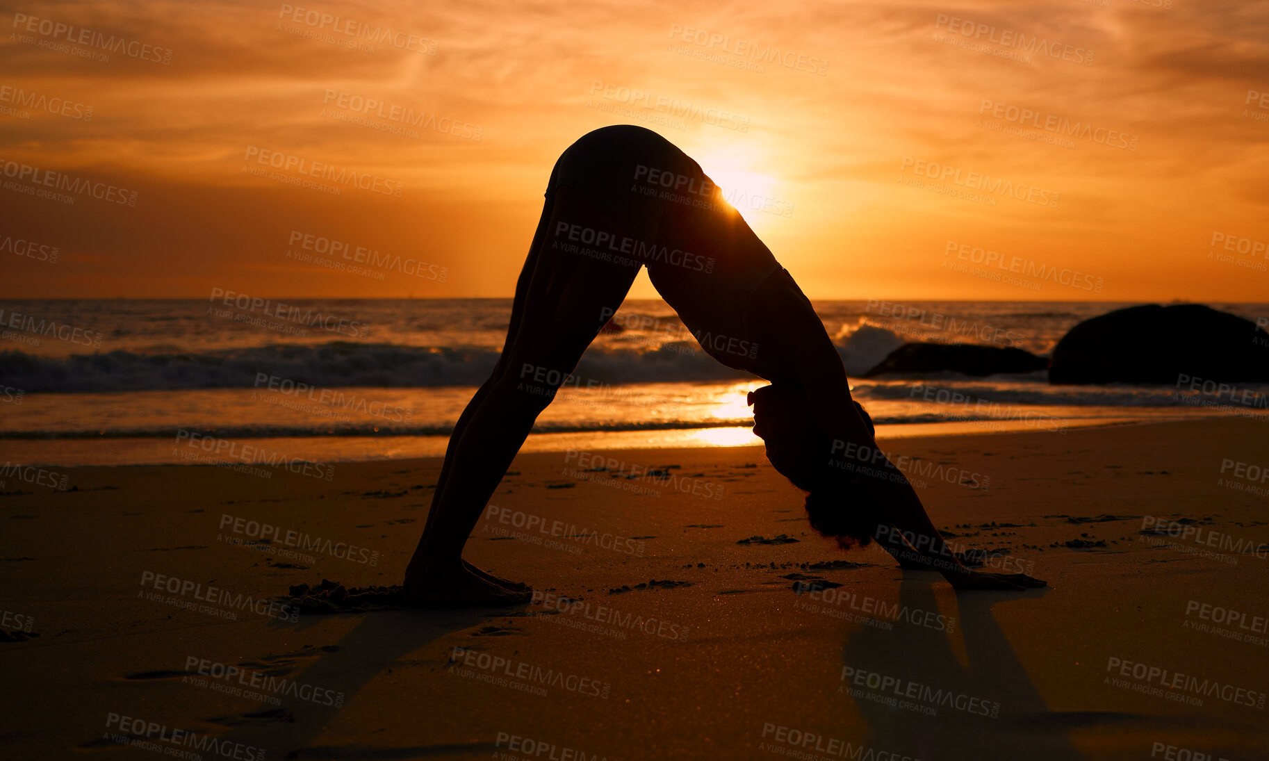 Buy stock photo Yoga, silhouette and downward dog on sunset beach, ocean or sea in workout or relax exercise training. Yogi, woman and sand stretching at sunrise healthcare wellness, fitness pilates or strong body