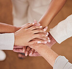 People, hands together and unity above in trust for community, agreement or teamwork at the office. Group piling hand for team collaboration, support or coordination for corporate goals in solidarity
