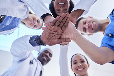 Buy stock photo Healthcare, teamwork and hands together in huddle for team building, collaboration and motivation at hospital. Doctors, happy faces of medical employees in solidarity and help or support from below.