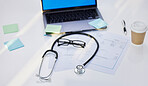 Laptop, stethoscope and medical paperwork in a office for research, diagnosis or test results. Sticky notes, coffee and glasses on a desk for doctor to read healthcare documents in hospital or clinic