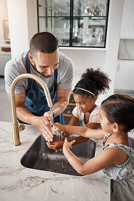 Buy stock photo Love, father and girls washing hands, happiness and bonding together in kitchen, before cooking and hygiene. Family, dad and female children cleaning, happy and teaching kids at home loving and learn