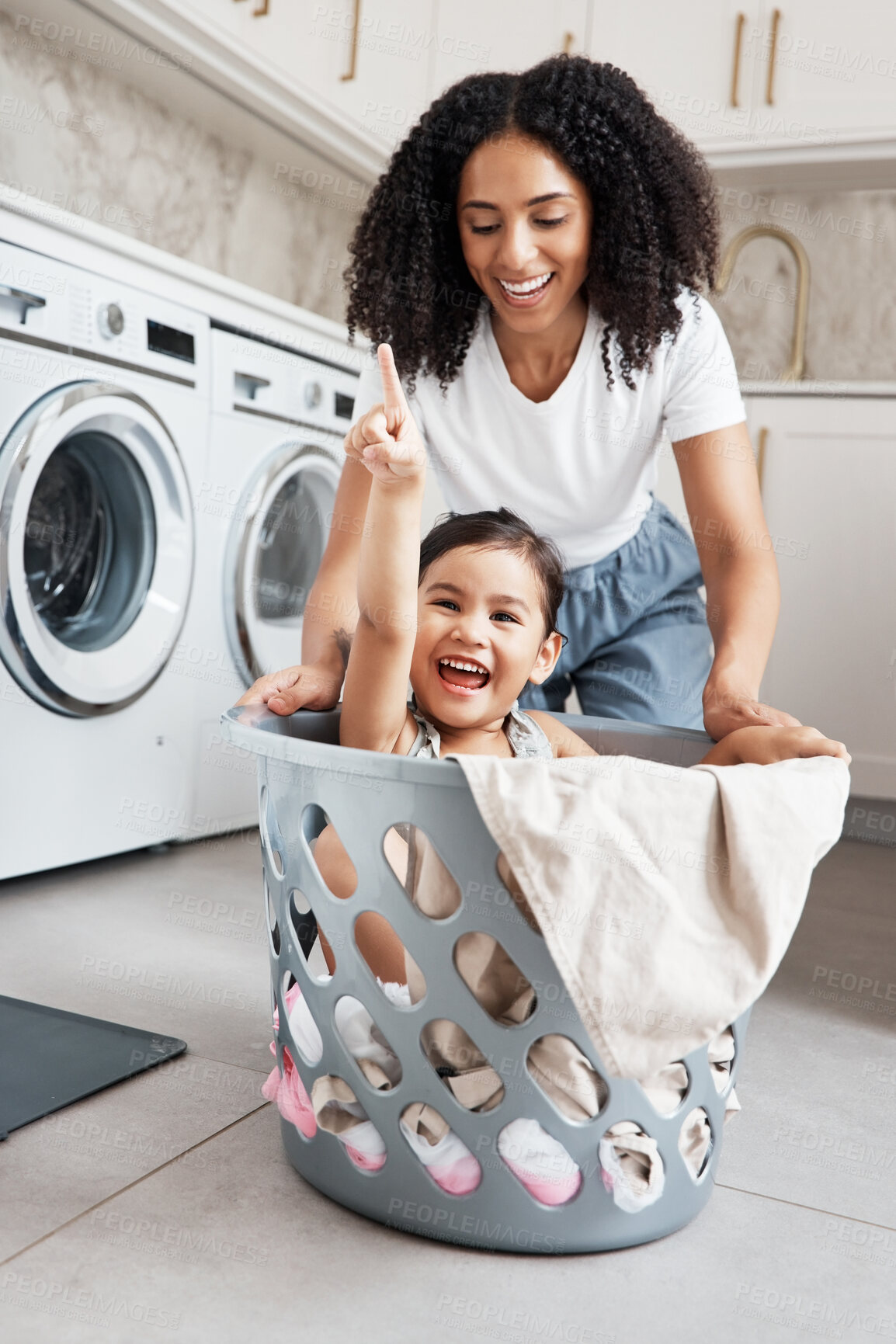 Buy stock photo Mom, laundry and girl kid in basket by washing machine for cleaning, bonding or comic time in house. Crazy fun, mother and daughter with happiness, love and playing in family home with smile on face