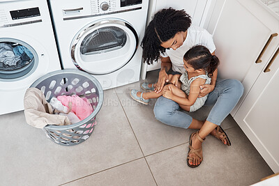 Buy stock photo Mom, girl child and hug by washing machine on floor for cleaning, bonding and care in quality time at house. Laundry, mother and daughter with happiness, love and embrace in family home from top view