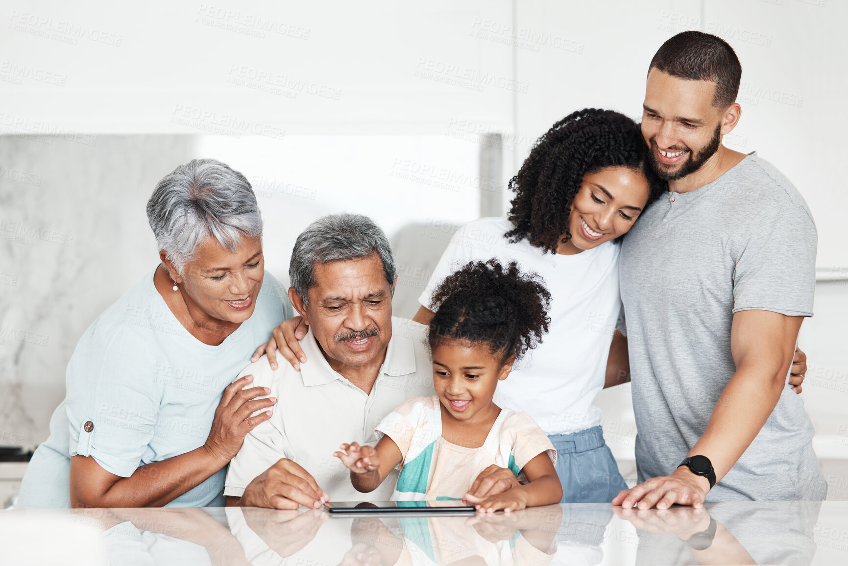 Buy stock photo Digital tablet, bonding and big family at their home watching a video on social media or mobile app. Love, happy grandparents and parents spending time with a girl child streaming a movie on a device