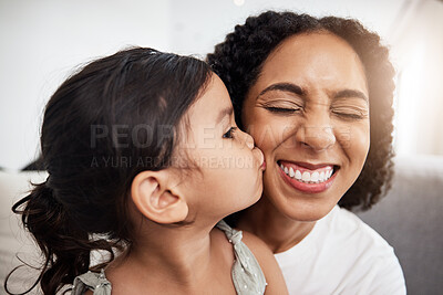 Buy stock photo Kiss, love and girl with mother on a sofa, happy and smile while bonding in their home together. Family, kisses and parent with child on a couch, bond and cheerful, loving and caring in a living room