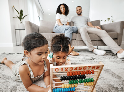 Buy stock photo Family home, children and floor with abacus for math learning, development and sibling teamwork. Children, carpet and education toys with mom, dad and sofa with smile, pride and happiness in house