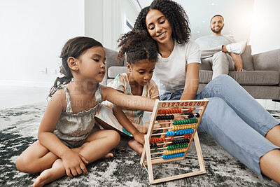 Buy stock photo Mother, children and floor with abacus for math learning, teaching or sibling teamwork in family home. Kids, carpet and education toys with mom, dad and sofa with smile, pride and happiness in house