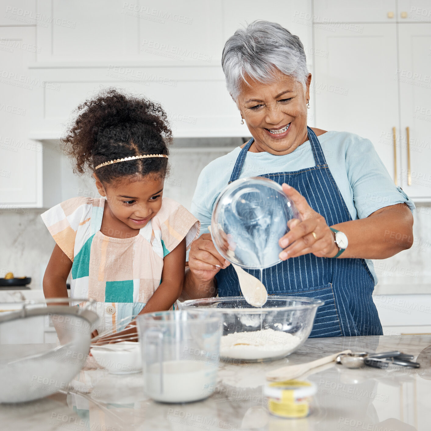 Buy stock photo Learning, cooking and grandmother with girl in kitchen mixing milk and flour in bowl. Education, family care and happy grandma teaching child how to bake, bonding and enjoying baking time together.