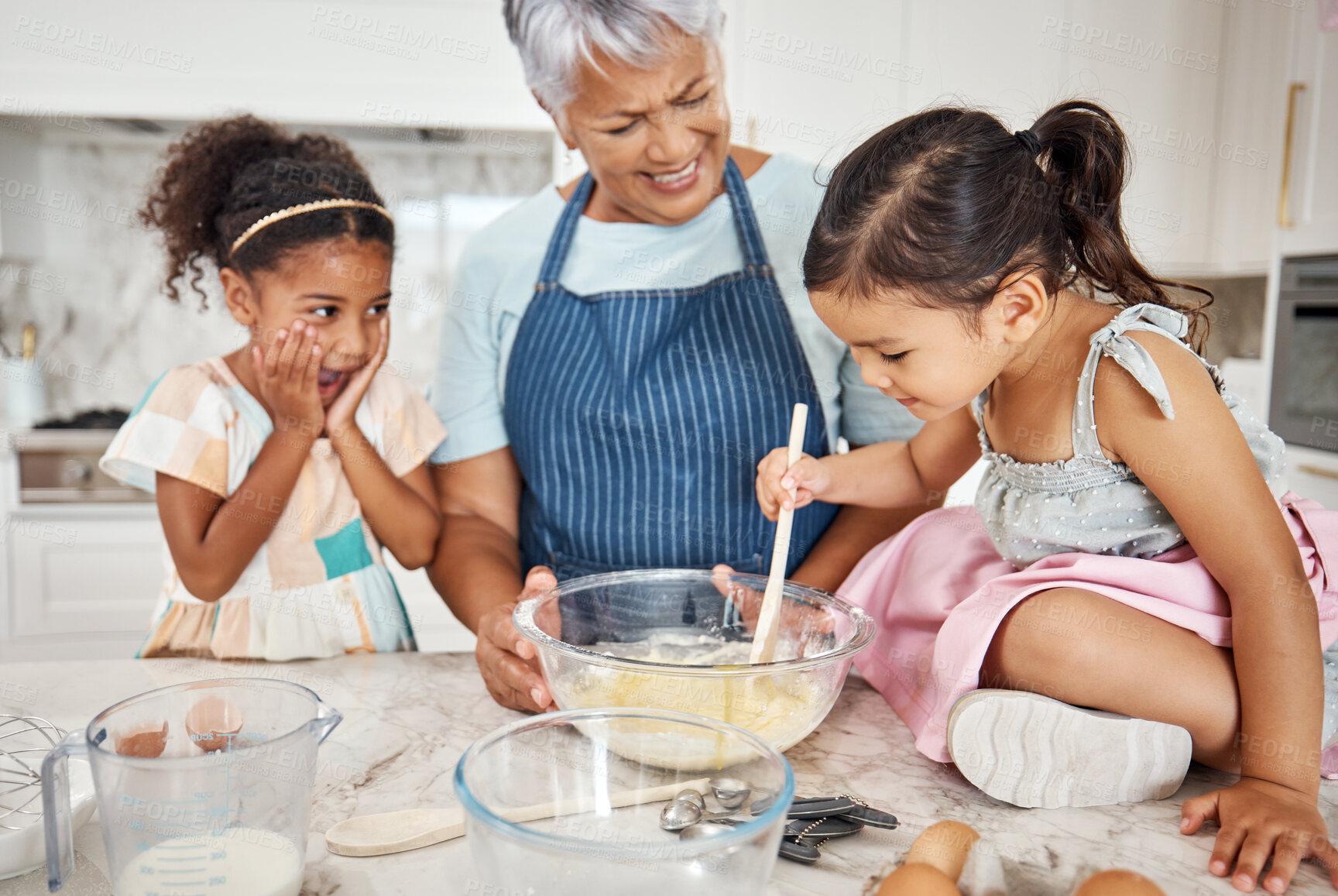 Buy stock photo Learning, grandmother and cooking girl in kitchen mixing baking dough in bowl in home. Education, family wow and surprised kid with grandma teaching children how to bake for child development