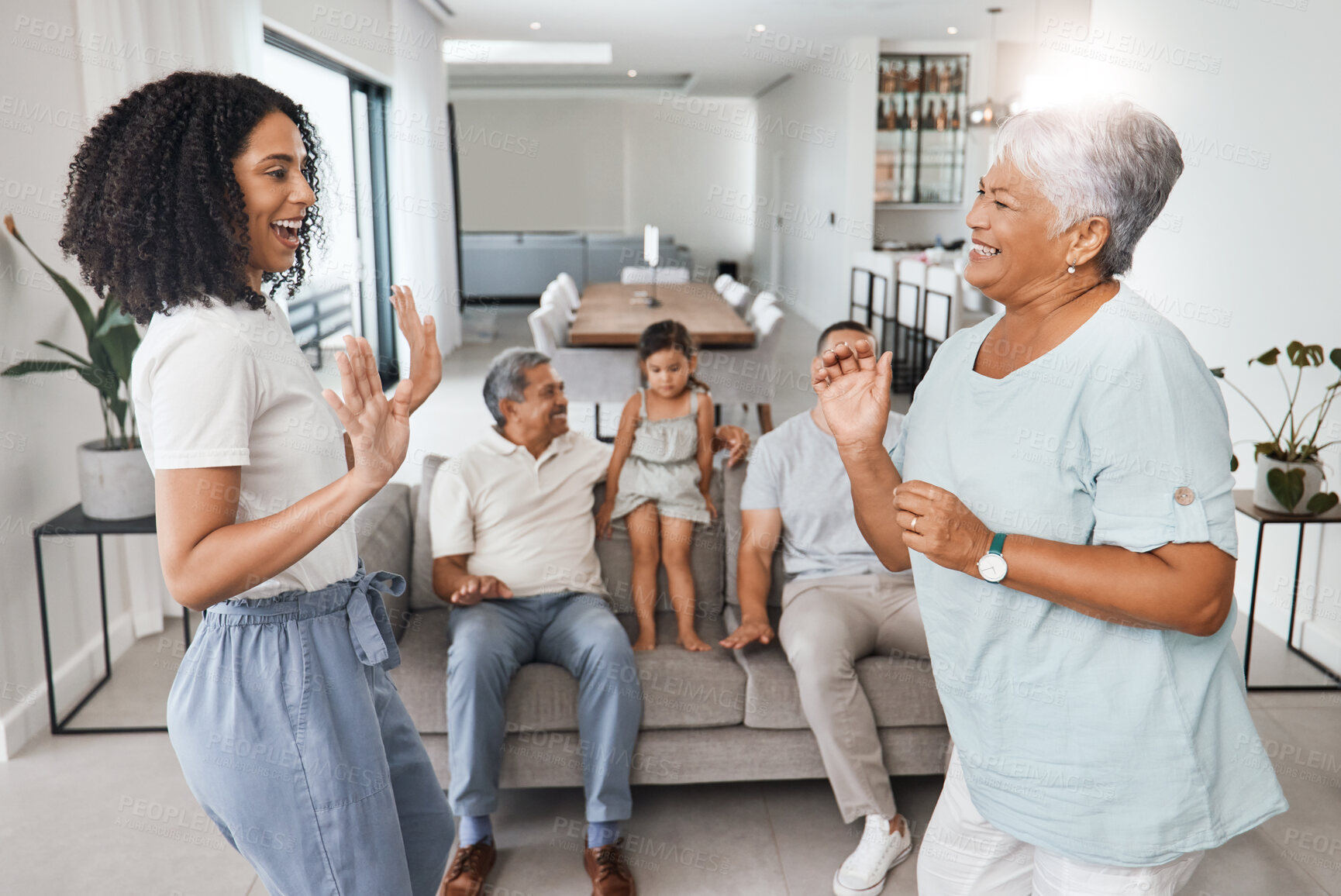 Buy stock photo Happy family, mother and daughter dancing with love, support and care together in home living room. Women, men and child or parents and grandparents in lounge for happy quality time and bonding