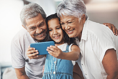 Buy stock photo Love, happy and girl taking selfie with her grandparents for social media in modern family home. Happiness, smile and excited child taking picture with grandmother and grandfather at house in Mexico.