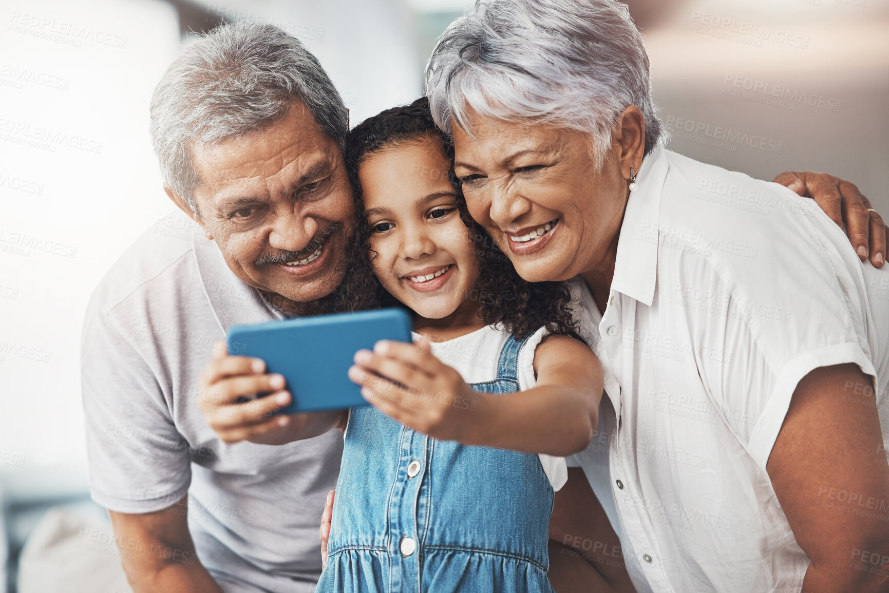 Buy stock photo Love, happy and girl taking selfie with her grandparents for social media in modern family home. Happiness, smile and excited child taking picture with grandmother and grandfather at house in Mexico.