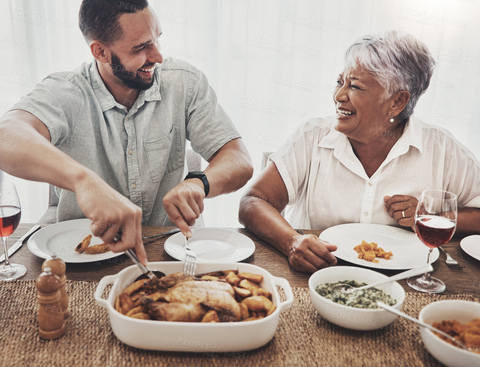 Buy stock photo Love, mother and adult son cut chicken, event and conversation with happiness, family and loving together. Happy, mama and male child with food, smile or enjoy party for quality time or weekend break