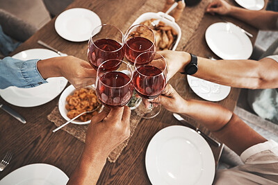 Buy stock photo Top view, hands and toast with red wine at dinner table for new year celebration in home. Party, cheers and group of friends, men and woman with alcohol or beverage to celebrate with delicious food.