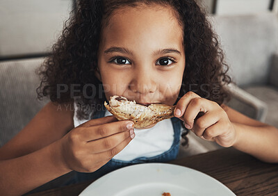 Buy stock photo Lunch, portrait and child eating chicken in the dining room at a party, dinner or event at home. Hungry, happy and girl kid enjoying food or meal at the table for snack, hunger or craving at a house.