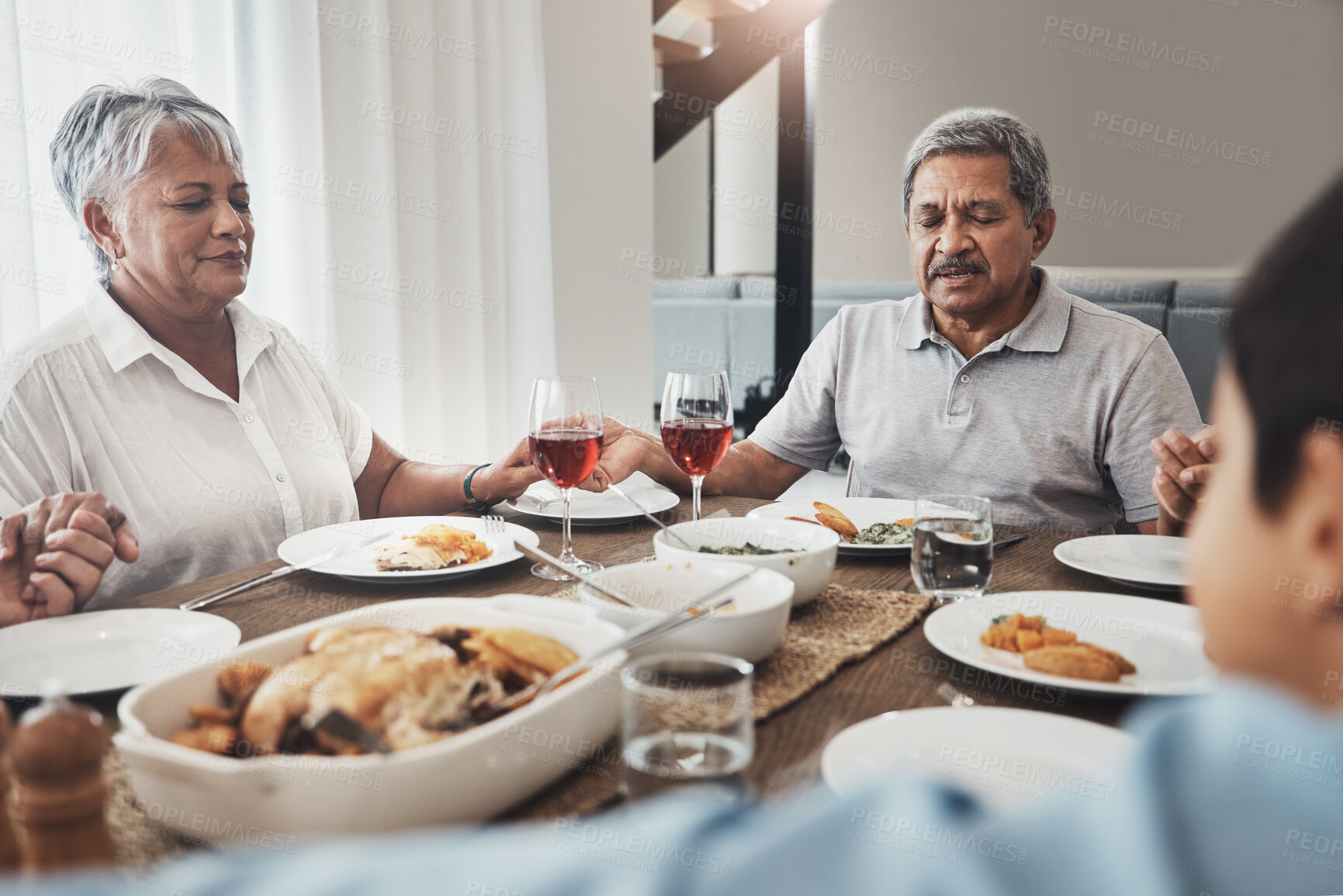 Buy stock photo Family prayer, holding hands and dinner buffet at home of grandparents with children at a table. Worship, praying and food for a holiday together in a house with spiritual gratitude for feast