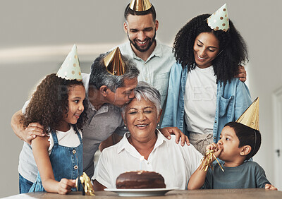 Buy stock photo Family, birthday celebration and senior woman at a table with a cake, love and care in a house. Children, parents and grandparents together for a party to celebrate excited grandma with dessert