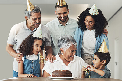 Buy stock photo Happy birthday, senior woman and family celebration at a table with a cake, love and care in a house. Children, parents and grandparents together for a party to celebrate excited grandma with dessert