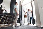 Man opening door, family visit and holiday with smile, loving and bonding together, care and vacation. Love, male invite parents into home and happiness with joy, excited and welcome with greeting