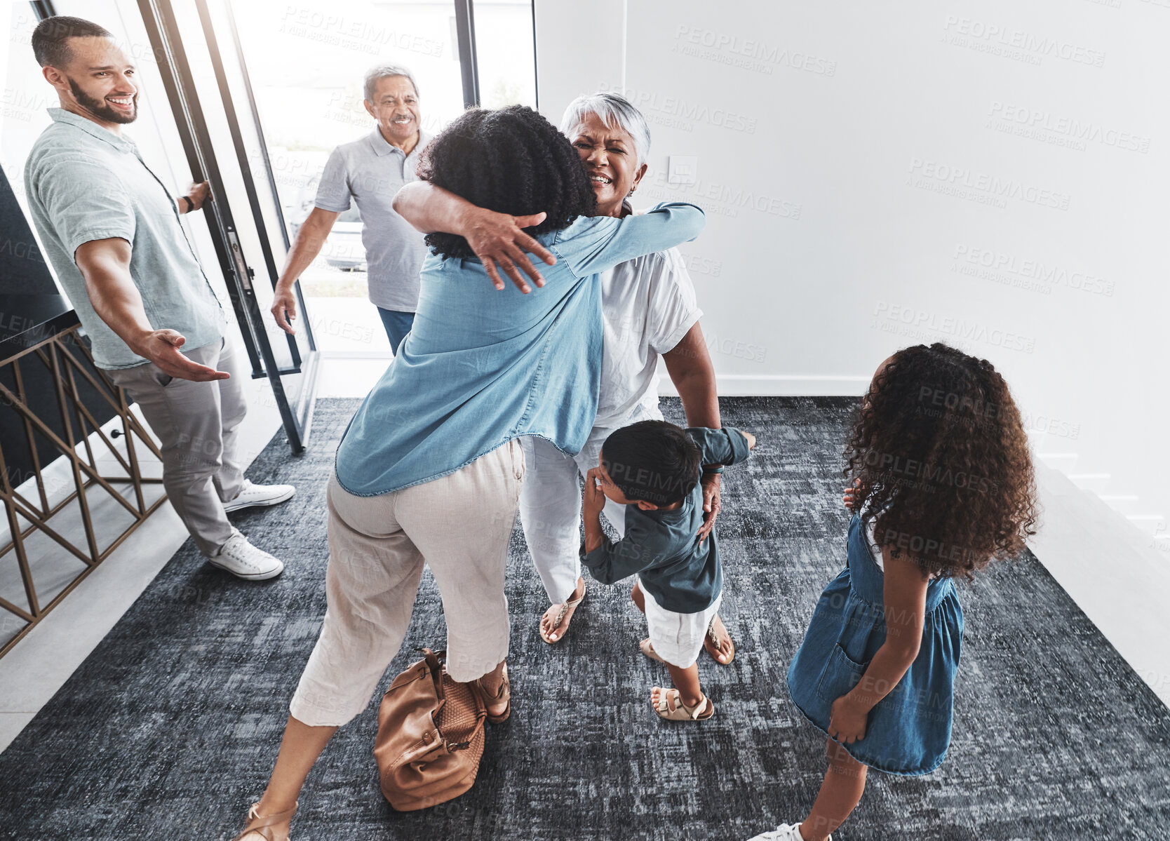 Buy stock photo Welcome, family hug and home of a mother, grandparents and children with happiness in a lounge. Living room, happy children and kids with love and parent care in a house with elderly parents