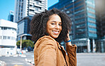 Portrait, urban city and black woman for travel, fashion influencer or selfie update of her journey in street. Walking, blue buildings and happy face of young person in road with natural hair or afro