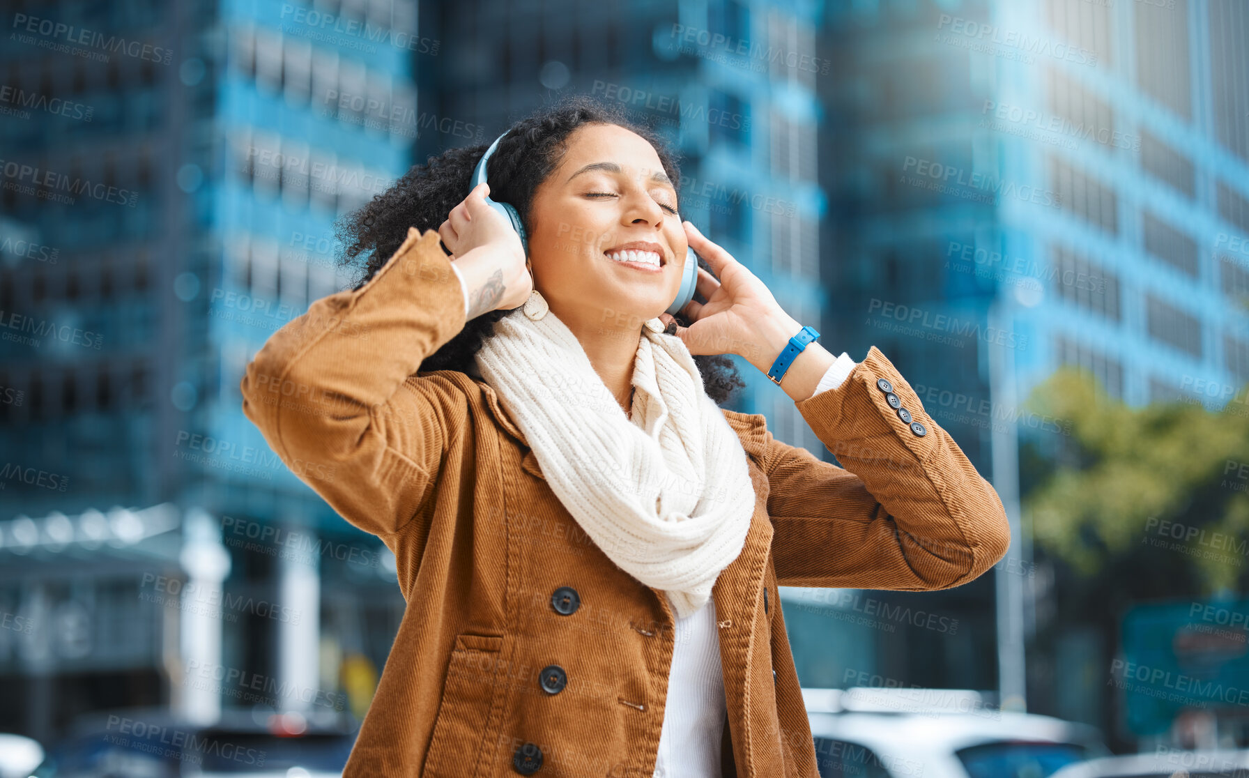 Buy stock photo Black woman, headphones and listening to music in city for travel, motivation and happy mindset. Young person on an urban street with buildings background while streaming podcast or audio outdoor