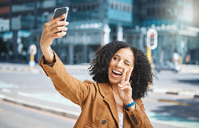 Buy stock photo Selfie, peace sign and funny woman in city for travel fun, vacation and social media update. Comic, smile and goofy influencer in the street with a hand emoji live streaming on a mobile in France