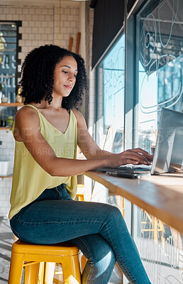 Buy stock photo Black woman, laptop or typing in coffee shop, cafe or restaurant for internet blog, research or startup planning. Thinking, student or freelance creative on remote work technology for small business